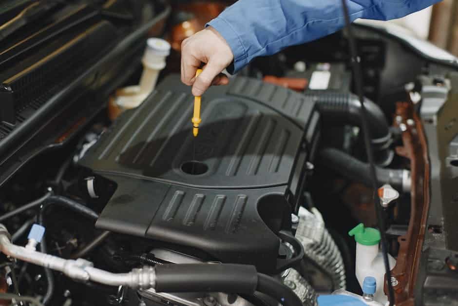 Image depicting a person checking the oil level of an Acura TL using the integrated oil level sensors and technology